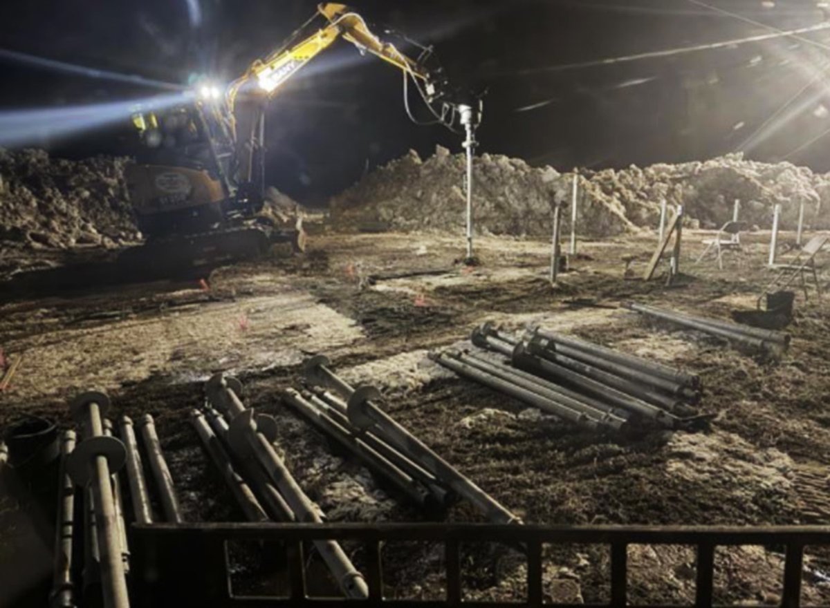 helical pile installation at night