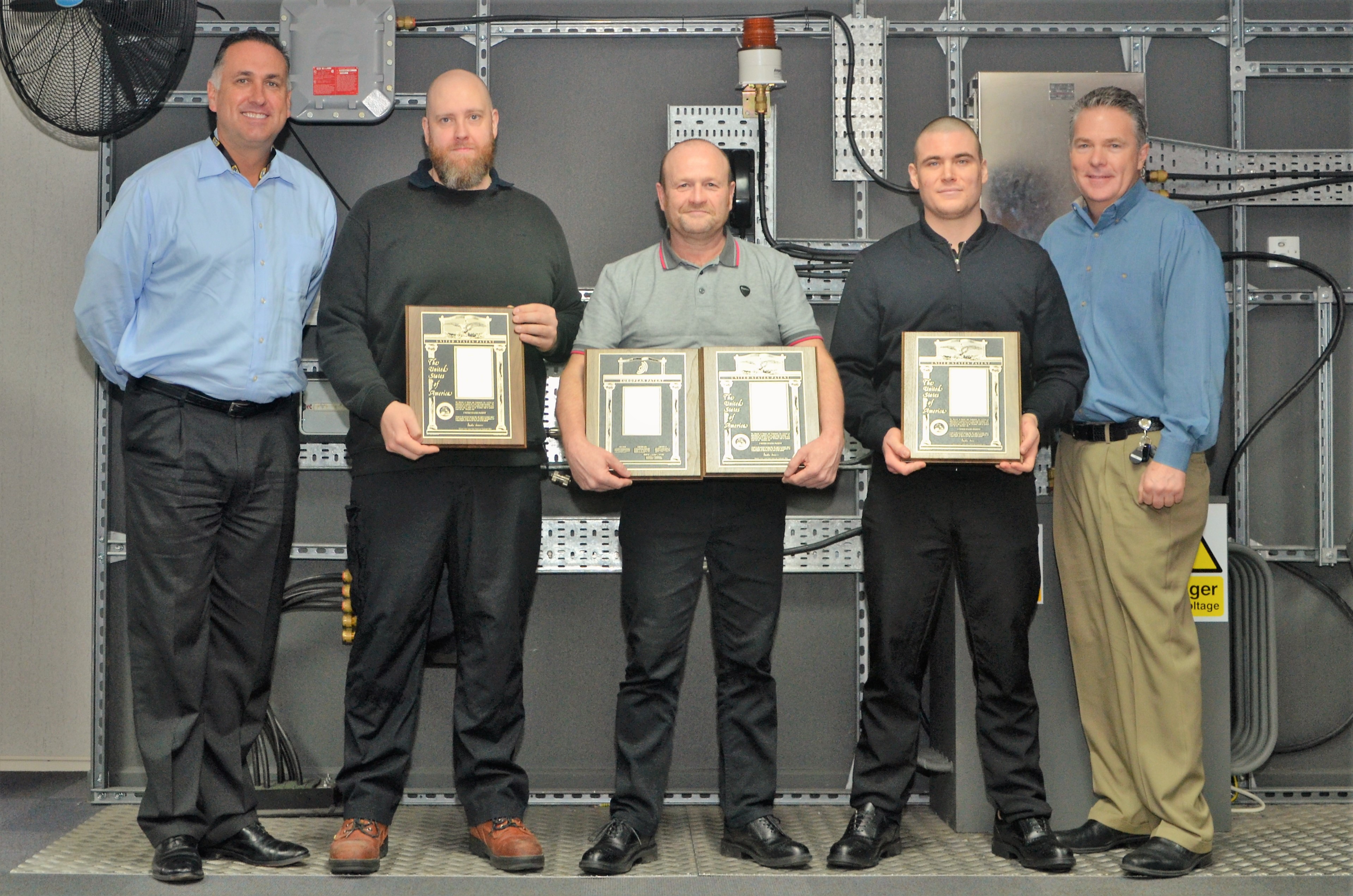 Carl Jackson, Jason Clark and Dean Renshaw are pictured being presented with Hubbell Patent Awards by Warren Jenkins, Vice President and General Manager or Hubbell Inc. and Steve Taafe, Director of Engineering at Killark.