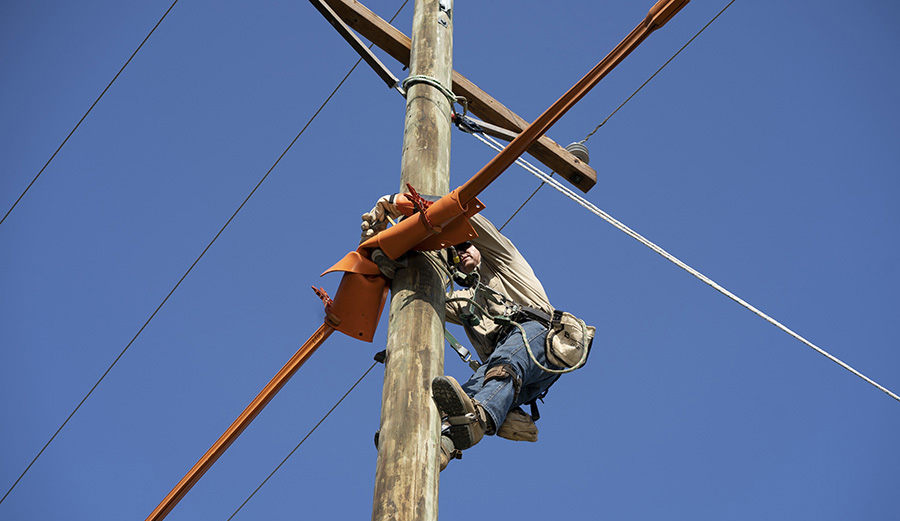 Lineman on Pole with Rubber Insulating Blankets and Cover-up