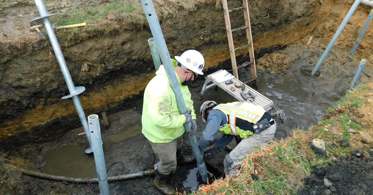 man installing Chance pipe shaft helical piles
